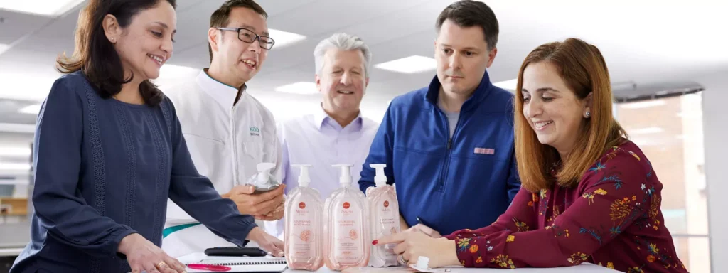 Kao - group of people looking at products